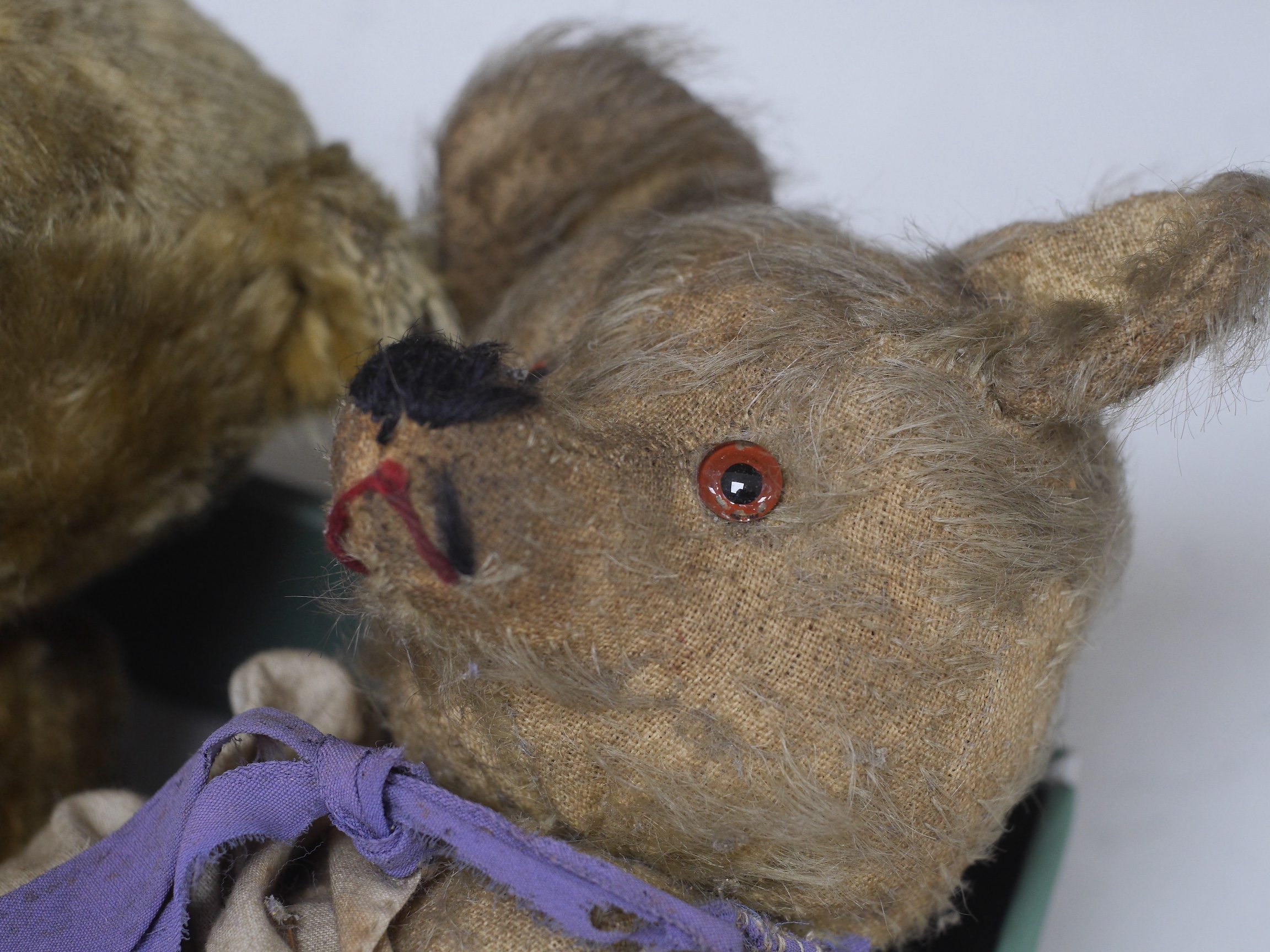 An early 20th century German hump backed plush teddy bear and three others, German teddy 30cm high. Condition - the German teddy has a short split on the back seam and glue on the front leg that needs removing and plush